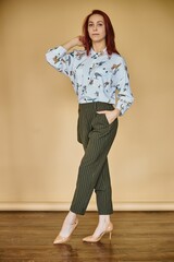 young business women on yellow background in green coctume