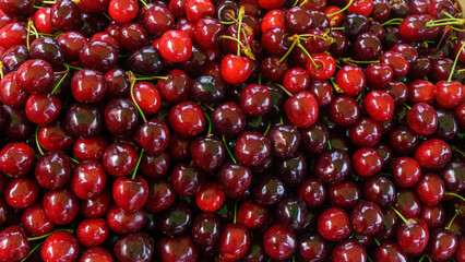 Sweet cherries at the counter. Bright vibrant vivid colors. Vitamins superfoods healthy diet. Harvest concept. Vegetarian food. Close-up view.