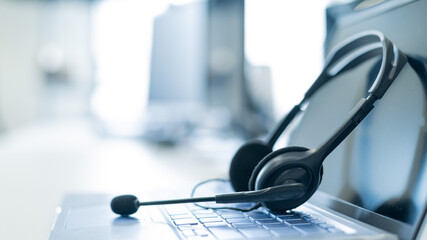 Call center operator desktop. Close-up of a headset on a laptop. Help desk. Workplace of a support...