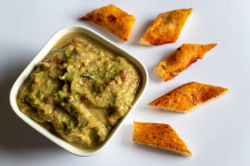 home made guacamole with pizza crusts 