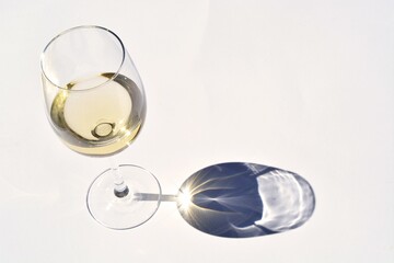 High angle view of a glass of white wine on the table under the lights - Powered by Adobe