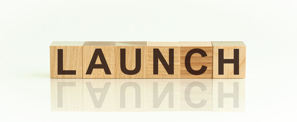 LAUNCH word made with building blocks on white background, front view, the image is mirrored in the...