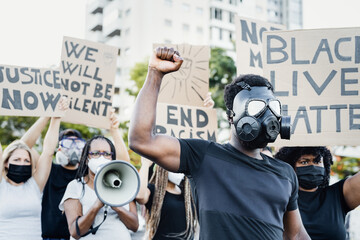 Activist wearing gas mask protesting against racism and fighting for equality - Black lives matter...
