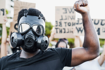 Activist wearing gas mask protesting against racism and fighting for equality - Black lives matter...