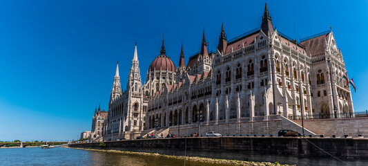 A view of the east shore of the River Danube in Budapest dominated by the Parliament Building during summertime