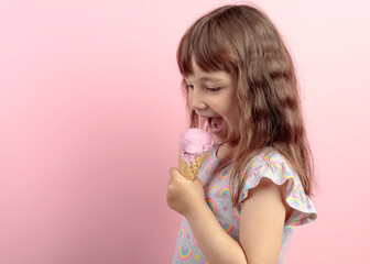 Happy little girl with delicious ice cream against pink background.