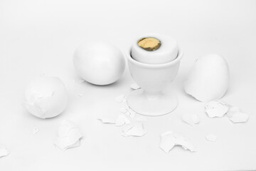 Obraz na płótnie Canvas White eggs, shells, a bowl of egg showing part of the yolk