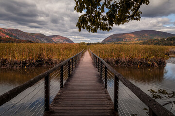 Fototapeta na wymiar Constitution Marsh bridge along the Hudson River, NY, with early fall foliage