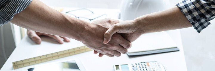 Two engineer shaking hands after consultation and conference new project