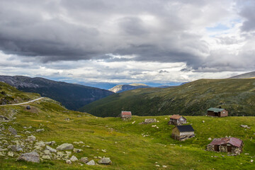Fototapeta na wymiar clouds above the wooden huts at the mountain road near Aurlandsvangen in Norway