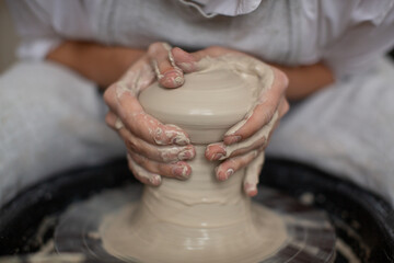 Female-ceramist creates a handmade clay product. Process ofHands in clay. Made with hands. Hands in clay. hand made. hands close up. High quality photo.