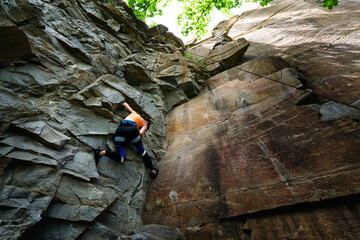 Climber extreme girl climbs a rock on a top rope. Summer of 2020, Buky canyon in Ukraine - 361178296