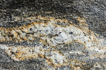 granite texture with veins of white mica. chips on the stones