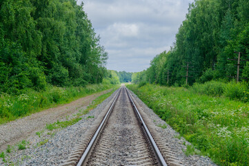 Railroad Background in the summer forest. New road. Industrial background