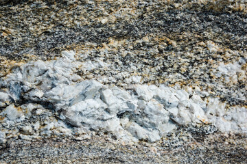 granite texture with veins of white mica. chips on the stones