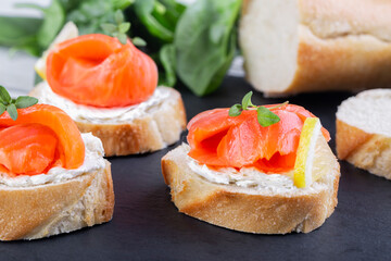 Salmon mini sandwiches on black slate board
