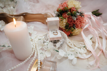 Wedding rings and other accessories close-up during the bride's gathering. Wedding