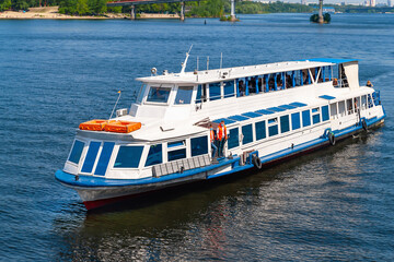 Fototapeta na wymiar Pleasure boat floats on the river. Navigation on the Dnieper.