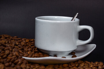 Coffee cup and coffee beans on black background