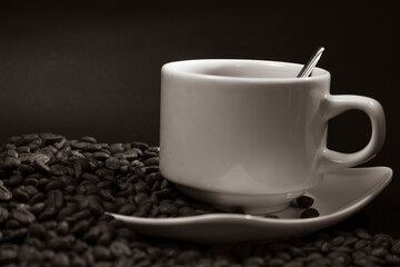 Coffee cup and coffee beans on black background