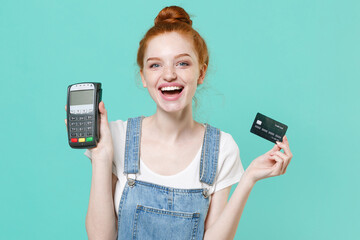 Funny young readhead girl in casual denim clothes isolated on blue turquoise background. People...