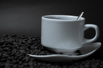 Coffee cup and coffee beans on black background