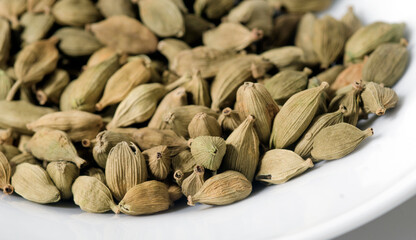 Cardamom in white bowl. Close-Up