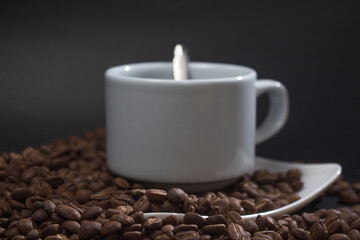 Coffee cup and coffee beans on black background
