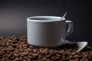 Coffee cup and coffee beans on black background