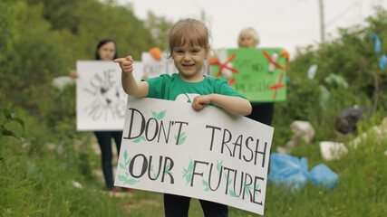 Girl volunteer holds protesting poster Don't Trash Our Future. Plastic nature pollution. Recycle