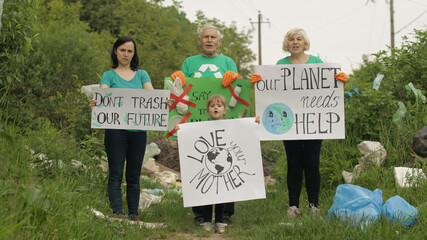Volunteer team holding encouraging posters. Calls out slogans. Reduce trash cellophane pollution
