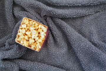 Top view of popcorn box on fluffy blanket