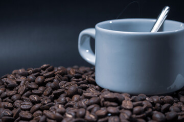 Coffee cup and coffee beans on black background