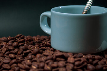 Coffee cup and coffee beans on black background