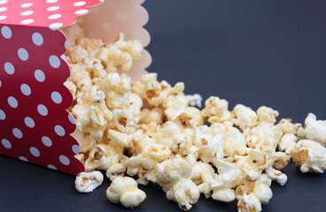 Popcorn falling out of the box on black background