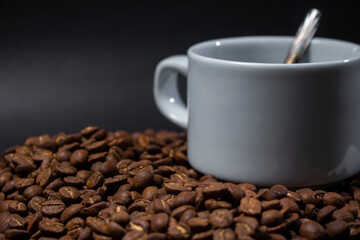Coffee cup and coffee beans on black background