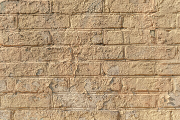 abstract background of an old brick wall painted beige close up
