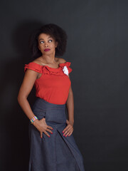 Sensual African American woman wearing a red summer top with a wondering look