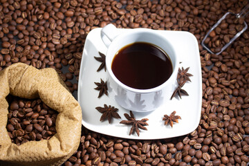 Coffee cup and coffee beans on black background