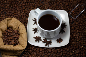Coffee cup and coffee beans on black background