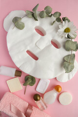 spa theme. face mask, set of towels, cosmetics and eucalyptus leaves