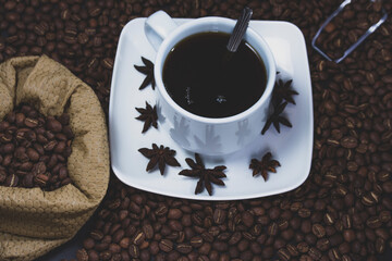 Coffee cup and coffee beans on black background
