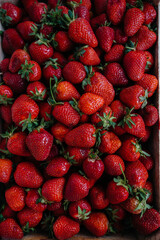 Ripe fresh strawberries close-up in a container for sale. Healthy diet
