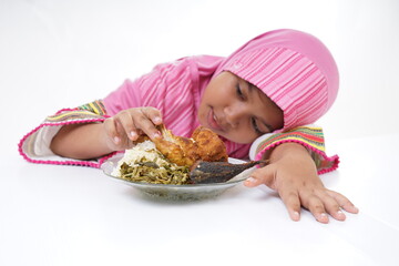 Asian Muslim girl eating Fried Chicken for lunch