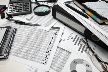 business office desk closeup - financial reports, analysis and accounting, set of documents, tables...