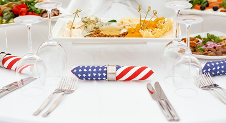 Catering. A serving table, ready for the arrival of guests. Stylized as USA. With American flag napkins and eat 