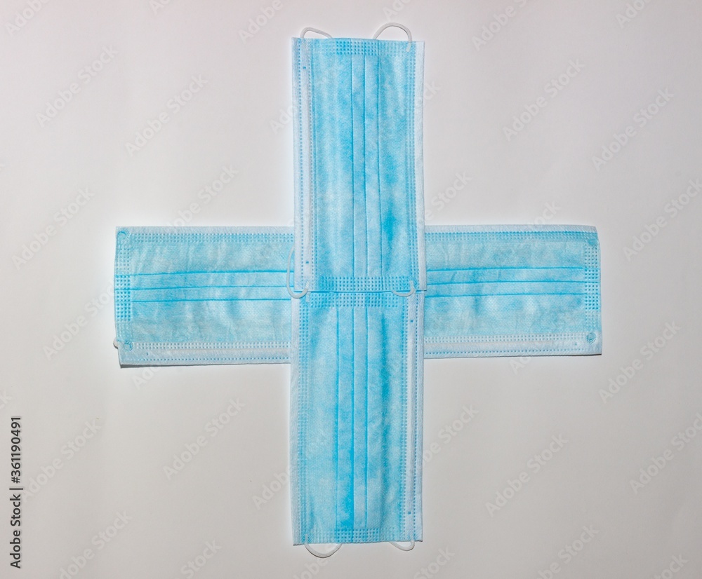 Poster closeup shot of the surgical mask form with cross pattern isolated on a white background