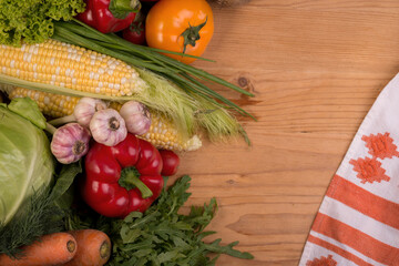 Assortment of fresh raw vegetables on a wooden table. Healthy food Top view background with empty space.