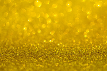 Background of sequins. Sequins in the background. Golden sparkling background. Festive abstract shiny background with flashing lights. The fabric glitters with bright colors. Fashionable fabrics spark