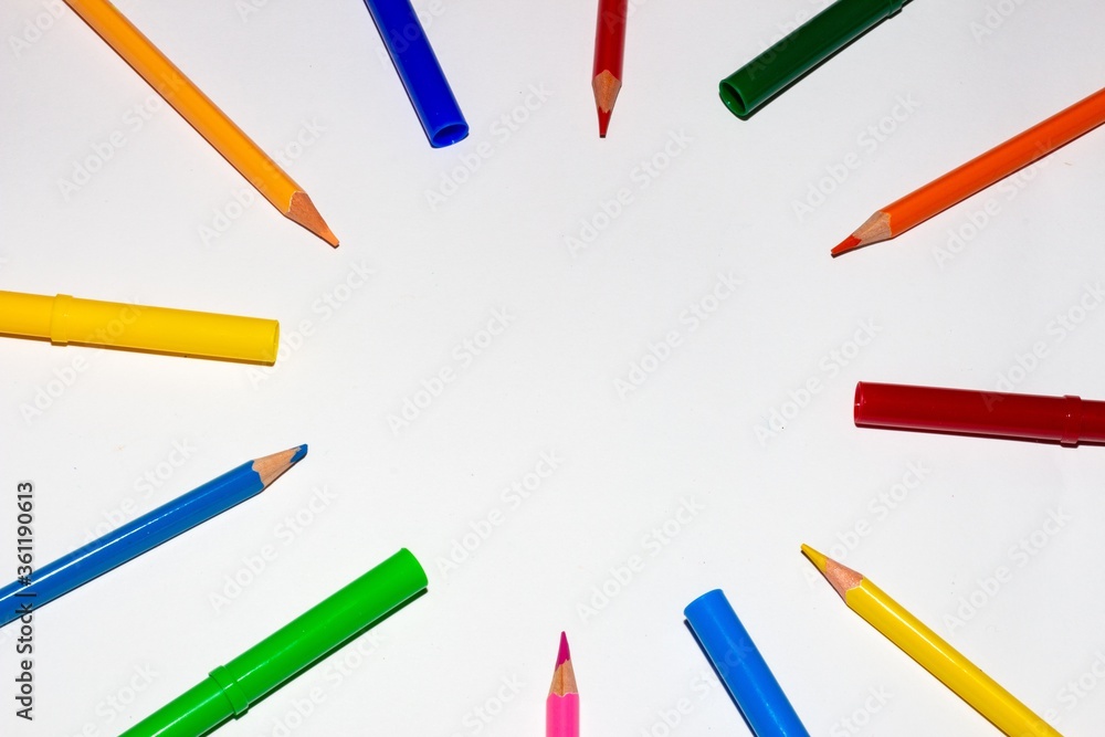 Poster closeup shot of colored pencils arranged in a circle pattern isolated on white background